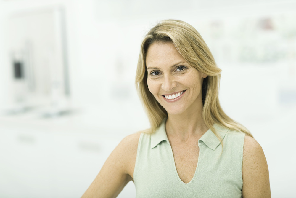 middle aged white woman smiling with bright white teeth